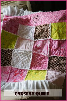 a pink and brown quilt on top of a white bed with the words car seat quilt