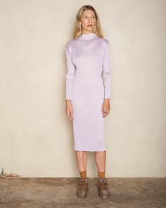 Turtleneck dress by Pleats Please Issey Miyake. A classic Pleats Please mid-length silhouette in radiant soft purple. Finished with an elegant lifted neckline and long sleeves. Signature vertical pleating with crisp and angular sleeve seams that can be folded completely flat for storage. 100% Polyester.Made in Japan. Pictured with Tapestry Low Tennis Shoes by Uma Wang. Purple Fitted Midi Length Dress, Purple Fitted Midi Dress, Fitted Purple Midi Dress, Purple Stretch Midi Dress, Elegant Stretch Purple Midi Dress, Elegant Purple Stretch Midi Dress, Purple Knee-length Winter Dress, Elegant Purple Winter Dresses, Purple Long Sleeve Dress For Winter