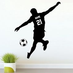 a soccer player jumping up to kick the ball with his name and number on it