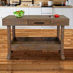 a kitchen with wooden floors and an island in front of the counter top, surrounded by white cabinets