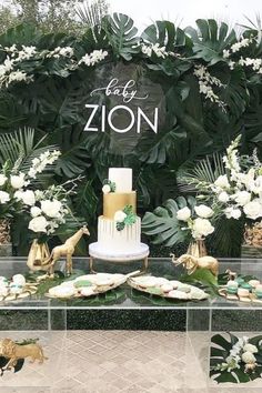 a table topped with lots of desserts and greenery next to a sign that says eat zon