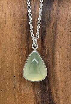 "A tranquil and glowing pear-shaped Prehnite cabochon is set simply into sterling silver and hangs on a 20\" sterling silver chain. Perfect everyday accessory. This one-of-a-kind necklace is ready to ship. Prehnite: 15 x 13mm Chain: 20\" Will arrive gift-boxed. My jewelry is handcrafted one piece at a time by me in my home studio in Portland, Oregon. If I can help you with any questions about this piece or any of my other products, please feel free to contact me: hello@paulla.com PIN IT on PINTE Green Prehnite Necklace For Gift, Chrysoprase Necklace With Large Stone, Green Amethyst Necklace For Gift, Untreated Green Pendant Necklace, Chrysoprase Necklace With Large Stone As Gift, Sterling Silver Necklace With Large Green Stone, Green Gemstone Necklace, Layered Necklaces Silver, Necklace Green