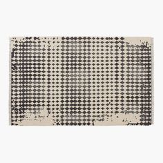 a rug with black and white squares on it