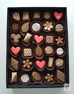 a box filled with lots of different types of chocolates