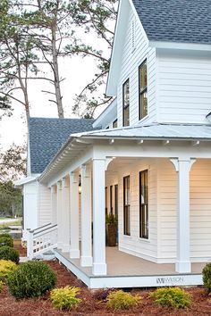 a white house with porches and columns