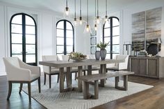 a dining room table and chairs in front of large windows