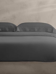 a bed with two pillows on top of it