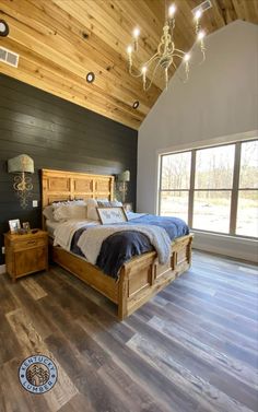 a large bed sitting inside of a bedroom on top of a hard wood floor