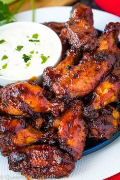 chicken wings with dipping sauce on a plate