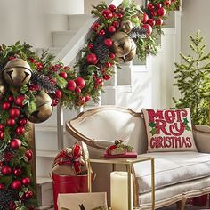 a living room decorated for christmas with red and gold decorations