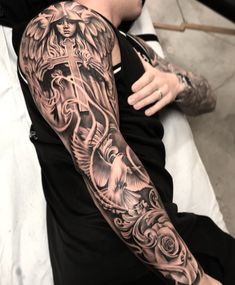 a man with a cross tattoo on his arm