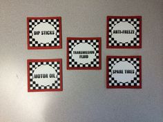 four stickers on the wall that say motor oil, stop, and checkered