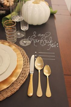 a place setting for thanksgiving dinner with pumpkins in the background