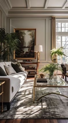 a living room filled with furniture and a painting on the wall above it's glass coffee table