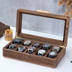 Get a handcrafted piece of art designed with elegant, minimalist curves and a glass cover; meet the minimalist watch box, one of our newest designs. This unique piece, made of first-class solid walnut wood, is not just a watch case; It's a statement of style and individuality. Each watch display box is handmade and customizable; This ensures that every detail reflects your personal taste. With its unique quality and distinctive design, this watch box for men adds a sophisticated touch to any spa Personalized Watch Box, Luxury Watch Box, Watch Box For Men, Wooden Watch Box, Engraved Watch, Wood Hinges, Mens Watch Box, Watch Organizer, Minimalist Watch