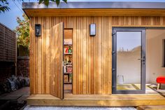 a small wooden house with sliding glass doors