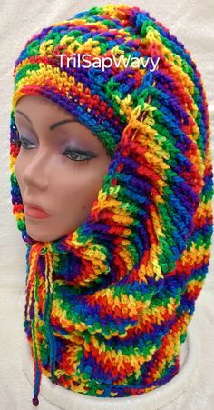 a mannequin head wearing a multicolored scarf