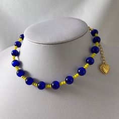 A handmade necklace of blue cat's eye gemstone and yellow glass beads. This beaded statement necklace is the perfect gift for yourself, your mom, or your loved one. ★ Complete the look ★ https://yourockjewels.etsy.com/listing/904010768/beads-hoop-earrings-chunky-hoops-bubbles Details * Blue Cat Eye Beads * Yellow Glass Beads * Necklace length: approximately 37cm - 14.57'' long including the clasp, with an extra 5cm - 2''extender. * The back is a regular clamp piece to secure perfectly. The closu Yellow Beaded Necklace With 8mm Beads As Gift, Yellow Gemstone Beaded Necklaces For Gifts, Yellow Necklaces With 8mm Beads For Gifts, Blue Necklace With Colorful Dangle Beads, Blue Glass Bead Necklaces, Blue Crystal Necklace With Colorful Beads, Yellow Czech Glass Beaded Necklace For Gift, Vintage Blue Necklace With Colorful Beads, Blue Glass Necklace With Colorful Beads