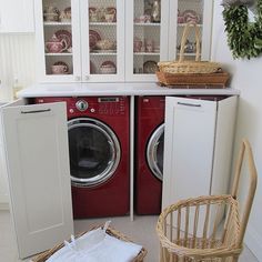 a washer and dryer sitting in a room next to each other with baskets on the floor