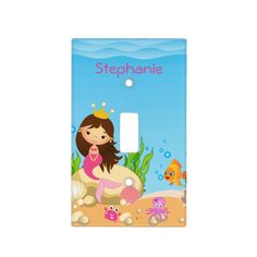 a light switch cover with a little mermaid sitting on the shell and other sea creatures