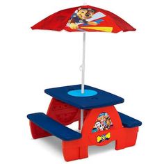 a children's sand and water table with an umbrella