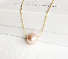 This simple yet elegant necklace is make with Edison pearl. Metallic pink pearl floating gorgeously on a delicate 14k gold filled cable chain. Edison pearl is about 9-10mm in sizes. 14k gold filled spring ring clasp. PLEASE NOTE: As you can see in the photos there are natural occurring blemishes and variation that give these pearls character. These are stock photos so please note pearls are vary in shape and color due to availability. Floating Pearl Necklace, Pink Pearl Necklace, Floating Necklace, Edison Pearls, Bridesmaid Pearls, Elegant Necklace, Metallic Pink, Elegant Necklaces, Pink Pearl