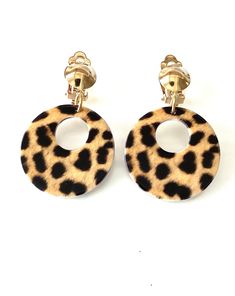 Clip on, leopard print hoop style earrings from Olivia Divine. Drop style, hoop earrings in a leopard print pattern. Clip on, with a gold tone metal clip on top. Lightweight, made from acrylic. Handmade deisgn. Length 5.5 cm approx. Tiny Leapord Print Earrings, Acrylic Hoop Earrings, Hoop Earrings Handmade, Leopard Print Pattern, Style Earrings, Print Pattern, Gold Tone Metal, Acrylic Prints, Earrings Handmade