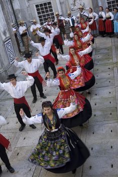 a group of people dressed in traditional clothing dancing