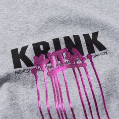 a group of pink hair combs on top of a gray t - shirt that says krink