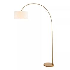 a gold floor lamp with a white shade on the base and a round light fixture