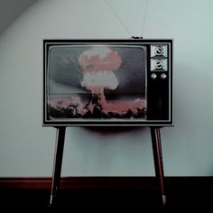 an old television sitting on top of a wooden stand