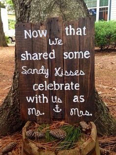 a wooden sign that says now we are sharing some sandy kisses celebrate with us as man and woman