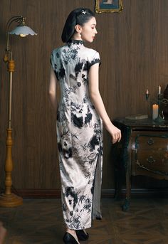 This elegant White and Black Qipao (Cheongsam) is crafted from luxurious silk fabric, featuring a classic high collar and short sleeves. The design showcases a timeless black-and-white color scheme, with delicate bamboo and floral motifs, evoking traditional Chinese ink painting. he black trim along the edges enhances the contrast, adding a refined finish. Perfect for formal occasions, this Qipao embodies the fusion of tradition and modern elegance, making it an ideal choice for any events. Mate Silk Qipao Dress, Elegant Fitted Silk Cheongsam, Black Qipao Dress, Black Qipao, White Qipao, Elegant Fitted Black Cheongsam, Chinese Ink Painting, Qipao Cheongsam, Qipao Dress