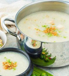 two pots filled with soup sitting on top of a table