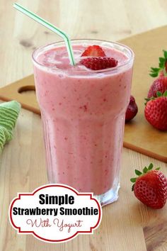 a smoothie with strawberries on the table