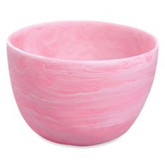 a pink bowl sitting on top of a white table