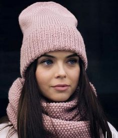 a woman wearing a pink hat and scarf