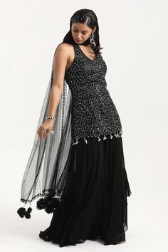 Black padded kurta with bead sequin embroidered stripe patterns and bead tassels. Comes with solid frill hem sharara and tasselled dupatta. - Aza Fashions Traditional Sleeveless Sharara For Evening, Sleeveless Sharara With Mirror Work For Evening, Evening Sleeveless Sharara With Mirror Work, Sleeveless Evening Sharara With Mirror Work, Elegant Sleeveless Sequined Palazzo Set, Bead Tassels, Kurta Sharara Set, Kurta Sharara, Sharara Set