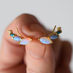 -18kt gold vermeil -lab created blue opal ombre stones  Earrings with a unique twist. These gorgeous colorful ear climbers are dainty but they are also striking and eye-catching. Made up of a mix of pastel colored opal hues. To extend the life of your gold plated and vermeil jewelry, avoid wearing when washing hands, showering, applying lotion, using harsh cleaning supplies or working out. To clean, buff gently with a soft and dry 100% cotton cloth or a microfiber cloth. Do not use jewelry cleaner on gold plated jewelry. Tennis Jewelry, Stones Earrings, Solid Gold Necklace, Ear Climbers, Forever Jewelry, Solid Gold Earrings, Vermeil Jewelry, Jewelry Ring Box, Mens Jewelry Bracelet