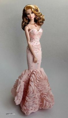 a barbie doll wearing a pink dress with ruffles on it's skirt