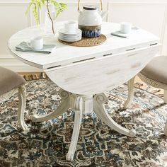 a white table with two chairs around it