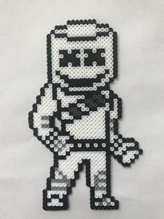 an image of a pixel art piece made out of black and white beads