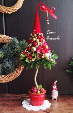 a potted christmas tree sitting on top of a wooden table