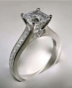 a white gold engagement ring with a princess cut diamond