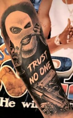 a man with a tattoo on his arm that says trust no one