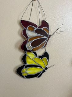 a stained glass butterfly hanging on the wall