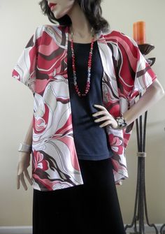 "You can get the look of the 70s with this Abstract Printed Kimono Cardigan.  It's combination of red, pink, white and brown blends together in a way to definitely make a fashion statement. This is the perfect lightweight layer kimono cardigan to wear with any outfit. It is fashionable and flattering. What a beautiful cardigan to wear or give as a git for any occasion. Wear it as a light covering with jeans, slacks, a dress, or bathing suit. The fabric is lightweight spandex lycra with a 10% str Red Bohemian Spring Cardigan, Red Vintage Cardigan For Spring, Vintage Red Cardigan For Spring, Red Bohemian V-neck Outerwear, Cardigan Plus Size, Printed Kimono, Wrap Gift, Cocoon Cardigan, Boho Kimono