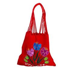 Chili red cotton hosts a bright bouquet of flowers embroidered on a colorful shoulder bag. The blossoms in Caribbean blue and purple with forest green foliage add to its festive feel. Working on the backstrap loom Petrona Perez and the Women Artisans Association craft the traditional Mexican morral a shoulder tote once used by both men and women. The warp threads are twisted then connected to become the shoulder strap. The reverse side is solid red. Red Bohemian Cotton Bags, Bohemian Red Cotton Bags, Red Spring Bags, Red Embroidered Bag, Red Bohemian Cotton Shoulder Bag, Red Floral Embroidery Bag For Daily Use, Red Floral Embroidered Bag For Daily Use, Red Bags With Floral Embroidery For Daily Use, Spring Cotton Shoulder Bag With Floral Embroidery