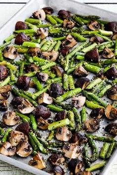 asparagus and mushrooms on a baking sheet