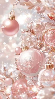 pink christmas ornaments are hanging from a tree with snow flakes and sparkles in the background